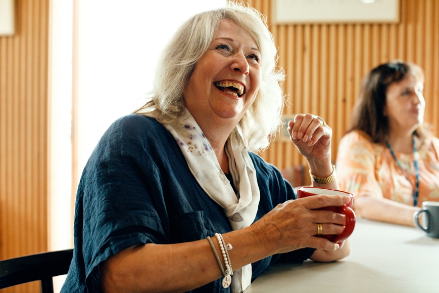 A woman laughing.